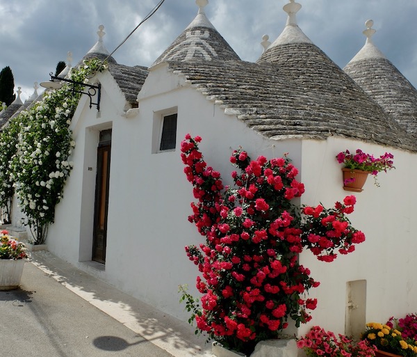Row of traditional trulli houses with conical roofs in Alberobello, a UNESCO World Heritage site.