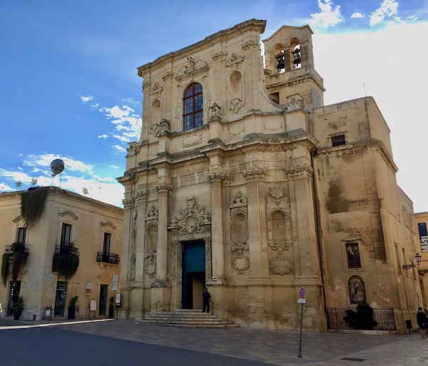 Illuminated Baroque façade in Lecce, showcasing intricate stonework