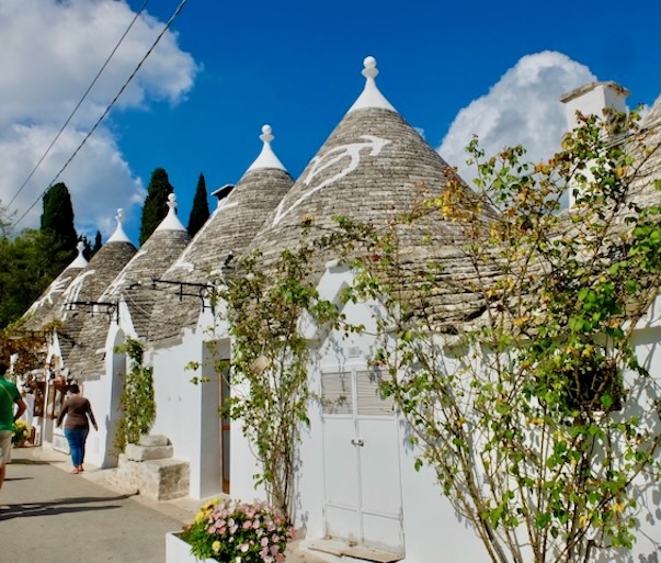 Row of traditional trulli houses with conical roofs in Alberobello, a UNESCO World Heritage site
