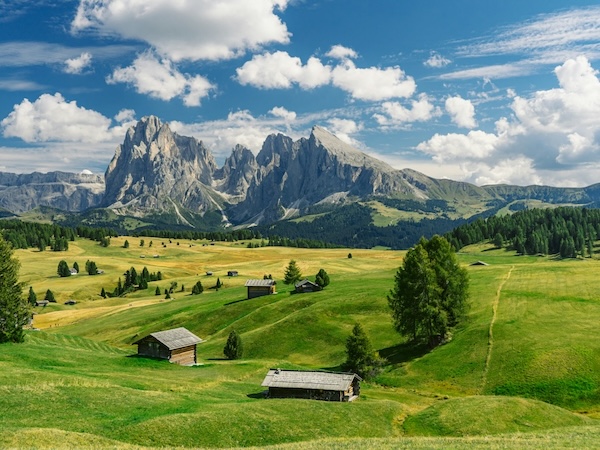 Panoramic view of the Dolomites with dramatic peaks and alpine meadows