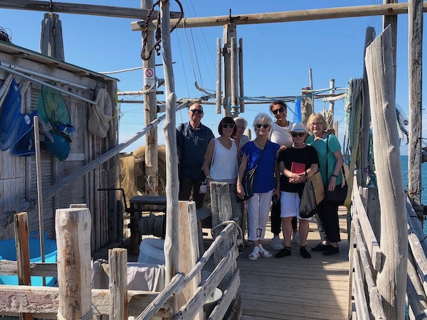 A small group tour enjoying the trabucco